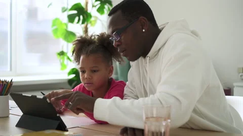 Young father, daughter using tablet and sitting at table during home schooling Stock Footage 172150304