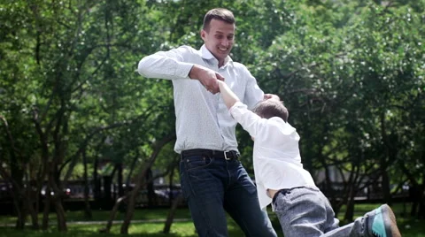 Young father having fun with her son in beautiful summer park, slow motion Stock Footage 64063304