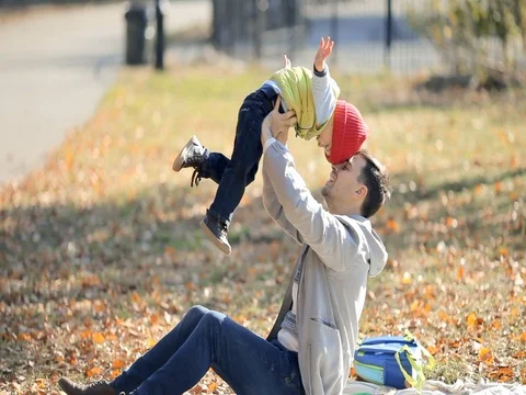 Young father having fun with his kid son in autumn park. Family picnic in park Stock Footage 74006500