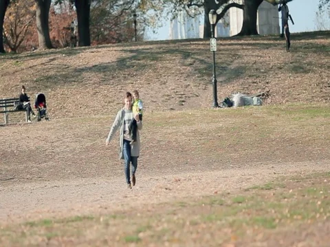 Young father having fun with his kid son in autumn city park Stock Footage 74006632