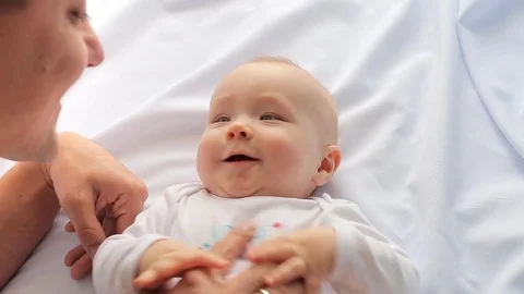 Young father is having fun with a young son, laughing on the bed Stock Footage 80305072