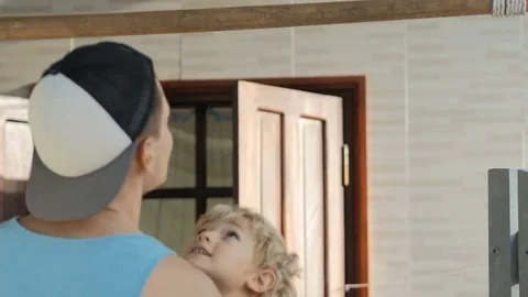 Young father helping child work out pull ups on horizontal bar. Stock Footage 77741812