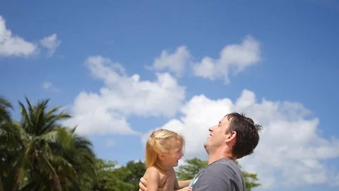 The young father joyfully throws his beloved daughter up, plays with her, they Stock Footage 88324764