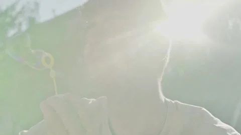 Young father makes a bubble of soap bubbles outdoors Video stock 143490641