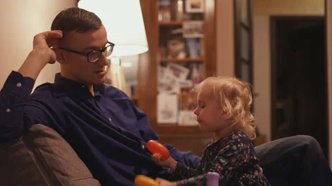 Young father spends time with his little daughter at home Stock Footage 107083199