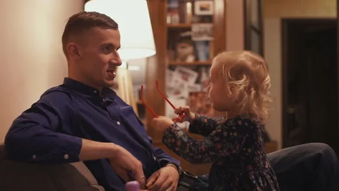 Young father spends time with his little daughter at home Stock Footage 107083367