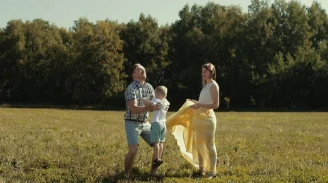 Young father throwing his cute son in the air and catching him in his arms Stock-Footage 68205481