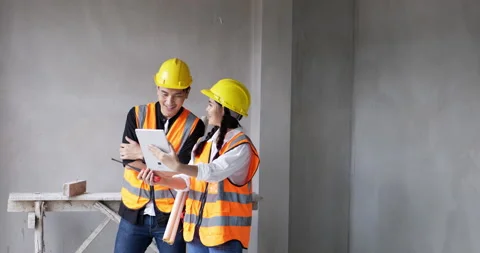 Young female and male foreman are video calling on their tablets. Stock Footage 194472653