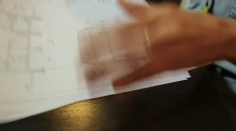 Young female architect holding a blueprint sheets with layouts and drawings of Stock Footage 59596372