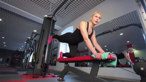 Young female athlete doing leg raises exercise at gym Stock Footage 73231833