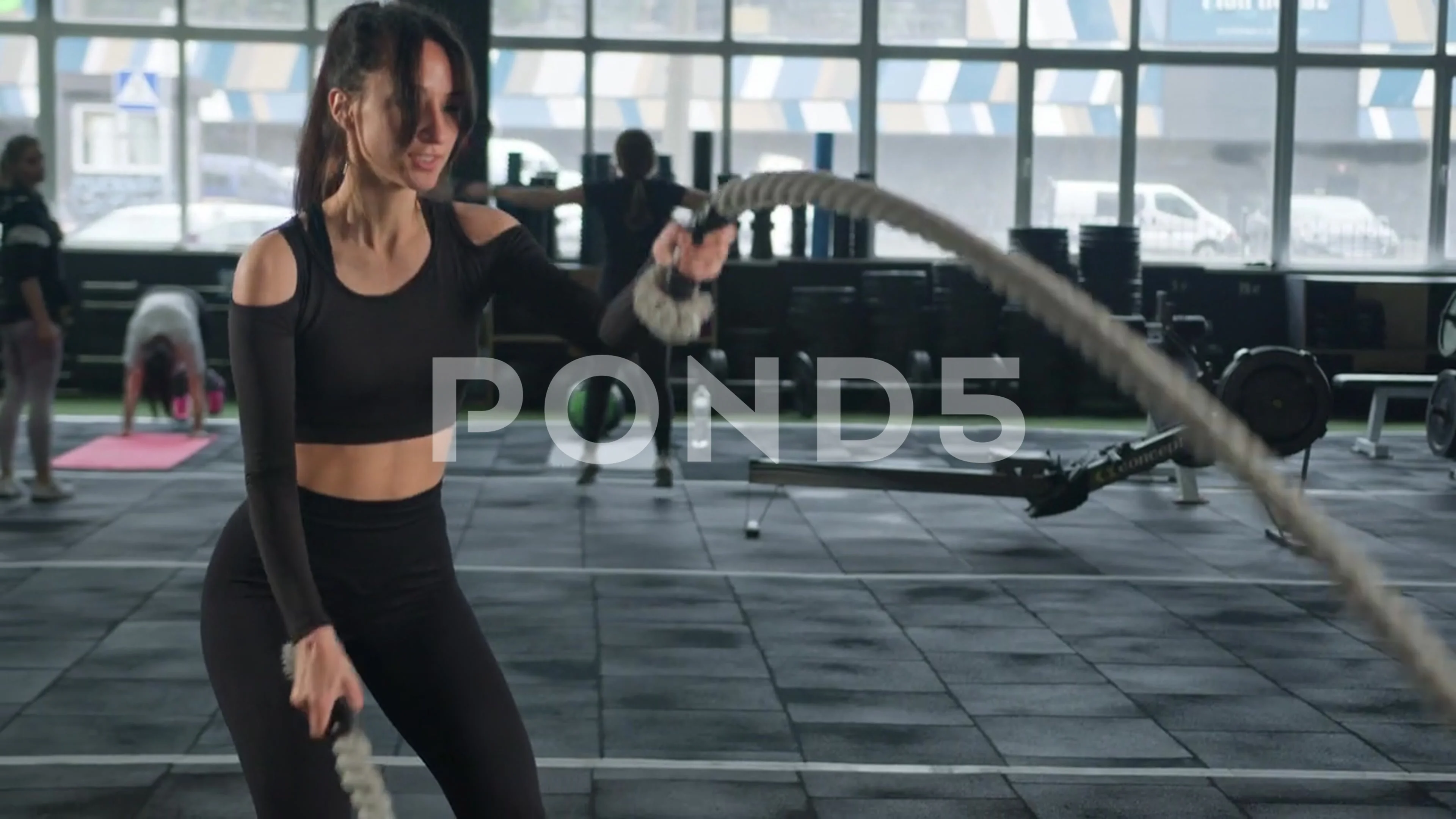 Working out Young athletic sportswoman exercising on gymnastic