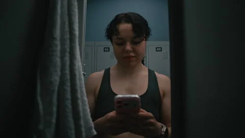 Young Female Athlete Using Smartphone After Workout Stock Footage 335394497