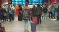 Young female with backpack standing in waiting room, looking at train schedule HD Footage