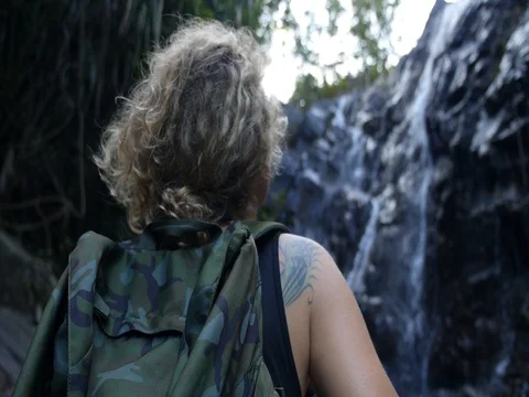 Young Female Backpacker Looking At Waterfall Stock-Footage 77094588