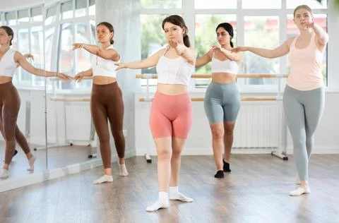 Young female ballet dancer executing dance moves with focused precision among Stock Photos