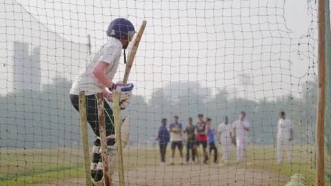 A young female batting in practice net session in a cricket academy, Mumbai Stock Footage 326757757