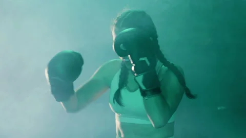 Young female boxer doing shadow fight Video stock 179363665