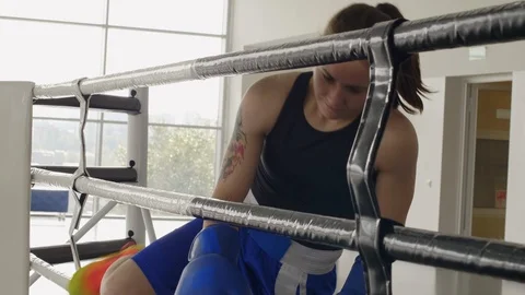 Young Female Boxer Going on Ring through Ropes Stock Footage 119090280