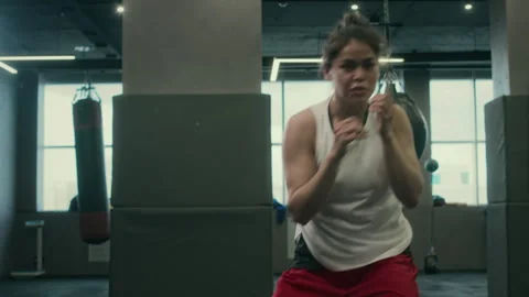 Young Female Boxer Performing Energetic Shadowboxing Routine at Gym Stock Footage 277558686