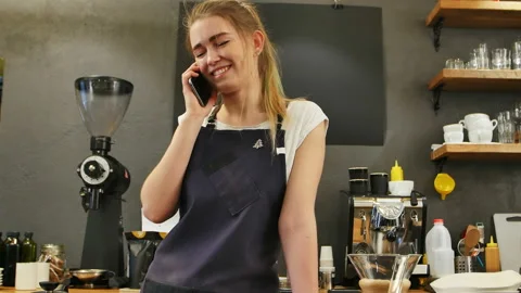 Young female calling using cell phone at work place Stock Footage 122091970