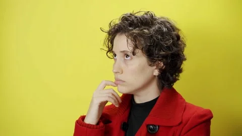 Young female cannot think of idea or solution and looks confused and puzzled Stock Footage 147329758