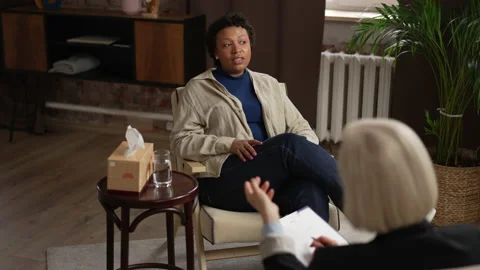Young female client is talking to psychoanalyst during psychotherapy session in Stock Footage 194425983