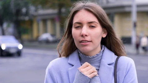 Young female is cold and getting warm, holds hands together Stock Footage 121835375