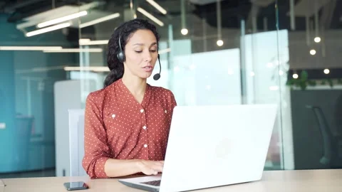 Young female corporate operator in wireless headset working in customer support  Stock Footage 301791089
