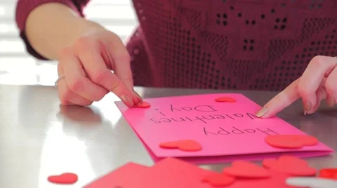 A Young Female Creating A Happy Valentines Day Card With Red Hearts Stock Footage