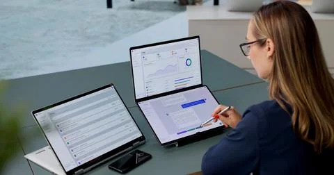 Young Female Customer Support Agent Chats Using AI Software On Laptop Screen. Stock Photos