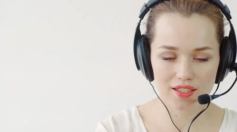Young Female customer support operator with headset and smiling Stock-Footage 61303901