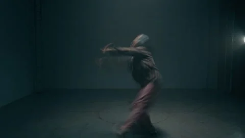 Young Female Dancer with Choppy Motion Blur in Dark Studio Stock Footage 335681043