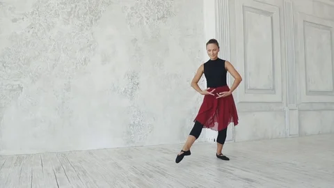 Young female dancer dancing on a light background. slow motion Stock Footage 94341339