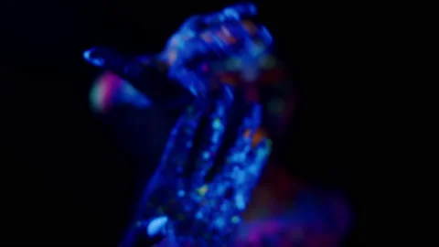 Young female dancer with a painted face and fluorescent multicolor drips on his Video stock 236813684