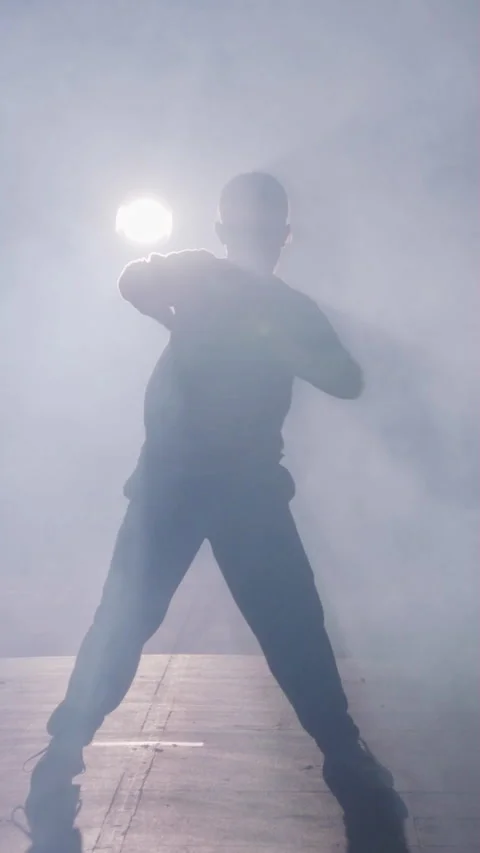 Young female dancer performing hip hop dance in slow motion with light and smoke Video stock 202130280