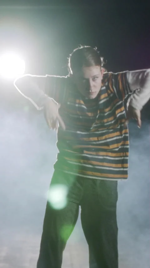 Young female dancer performing hip hop dance in slow motion with light and smoke Stock Footage 202131571