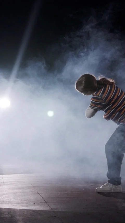 Young female dancer performing hip hop dance in slow motion with light and smoke Stock Footage 202133312