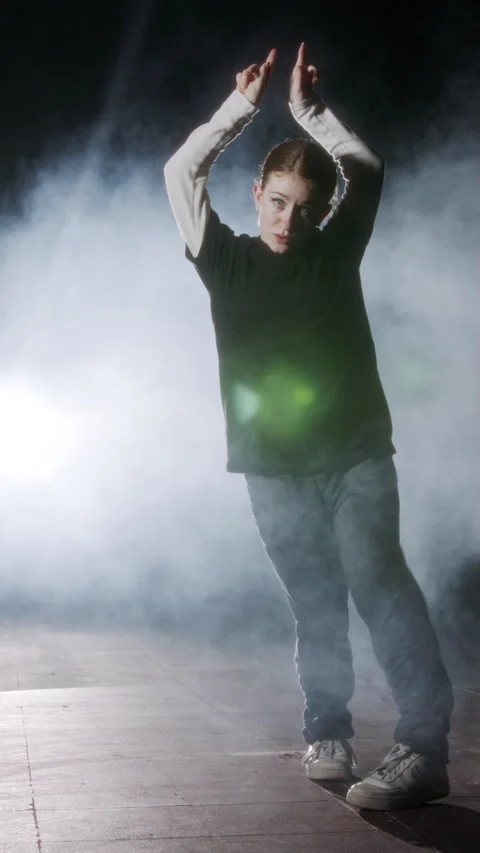 Young female dancer performing hip hop dance in slow motion with light and smoke Stock Footage 202133477