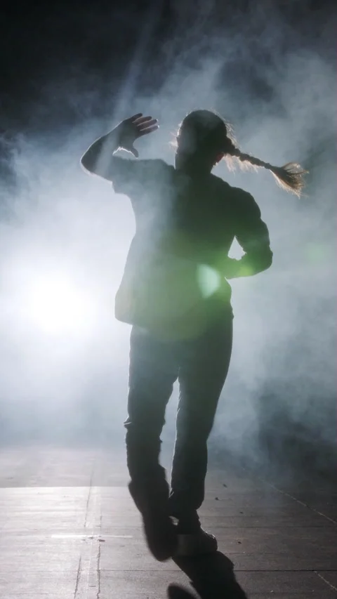 Young female dancer performing hip hop dance in slow motion with light and smoke Video stock 202133589