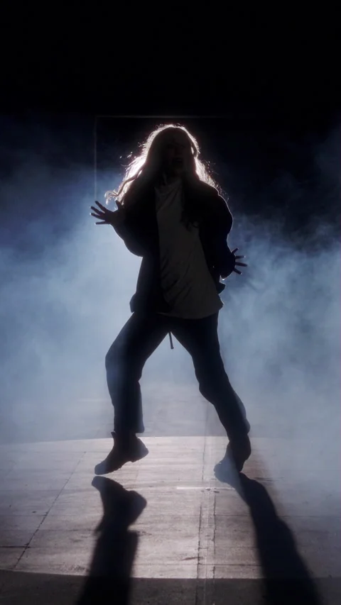 Young female dancer performing wild hip hop dance with strobe light and smoke Stock Footage 202131243