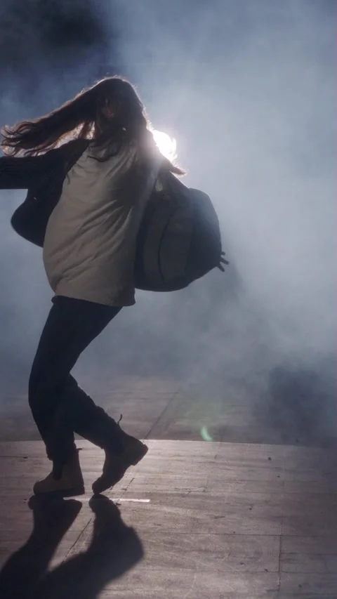 Young female dancer performing wild hip hop dance with strobe light and smoke Stock Footage 202131499