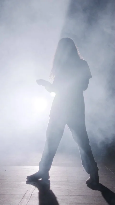 Young female dancer performing wild hip hop dance with strobe light and smoke 스톡 동영상 202133868