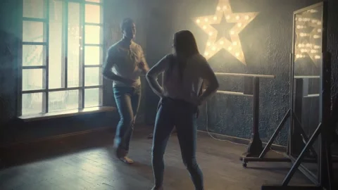 Young Female Dancer Is Teaching Passionate Latin American Dancing To Young Ma 動画素材 142948344