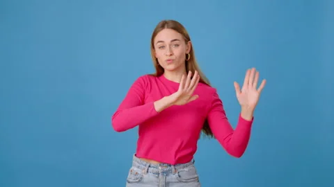 Young female dancing amusingly and making waves with hands Stock Footage 262756038