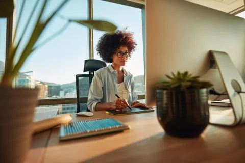 Young female designer using graphics tablet while working with c Stock Photos