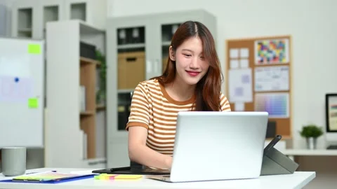 Young female designer using pen tablet and color palette while working in a.. 스톡 동영상 312437347