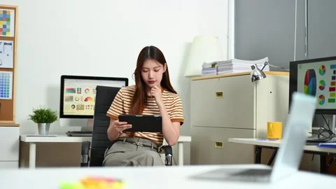 Young female designer using pen tablet and color palette while working in a.. 스톡 동영상 312437578
