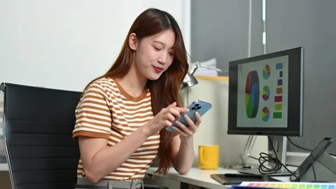 Young female designer using pen tablet and color palette while working in a.. Vídeos de archivo 312437590
