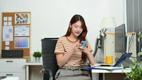 Young female designer using pen tablet and color palette while working in a.. Stock Footage 312849346
