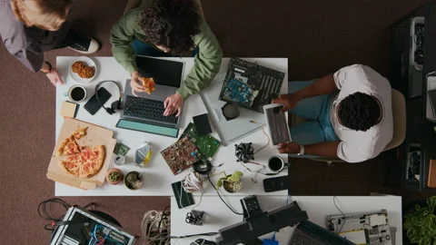 Young Female Developer Coding on Laptop when Male Coworker Coming up to Her Desk Stock Footage 312458164
